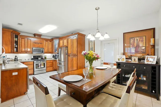 a large kitchen with a table and chairs