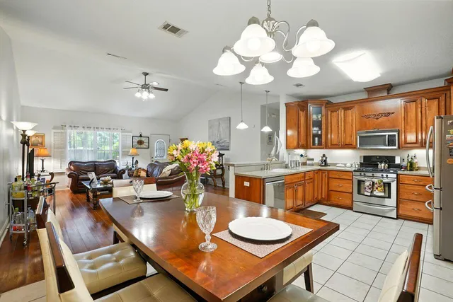 a large kitchen with a table and chairs