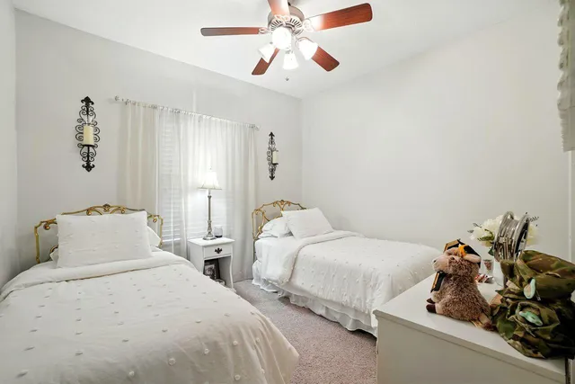 a bedroom with two beds and a chandelier