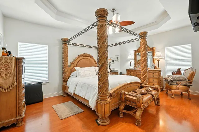 a spacious bedroom with a bed and a chandelier