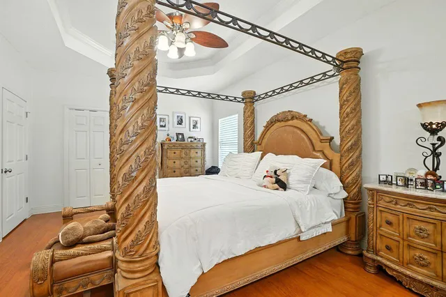 a bedroom with a bed and a chandelier