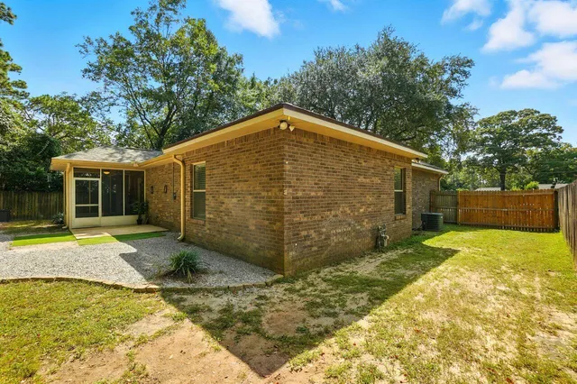 a backyard of a house with table and chairs