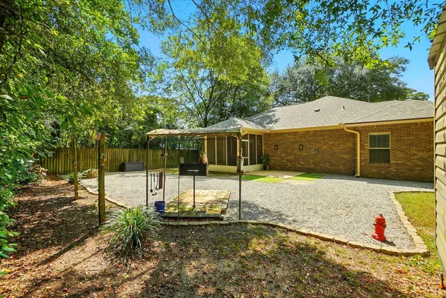 a backyard of a house with a table and chairs