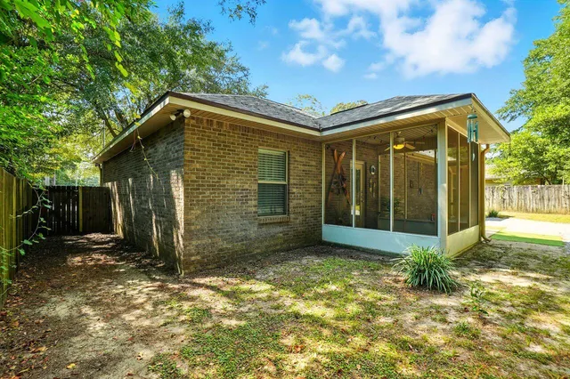 a view of a house with backyard and porch