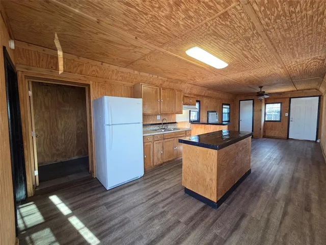 a kitchen with stainless steel appliances granite countertop a refrigerator a sink and a stove