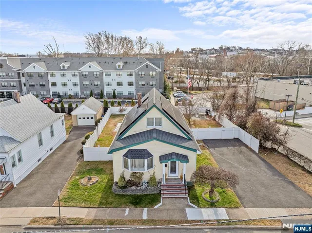 a view of a white house with a ocean view