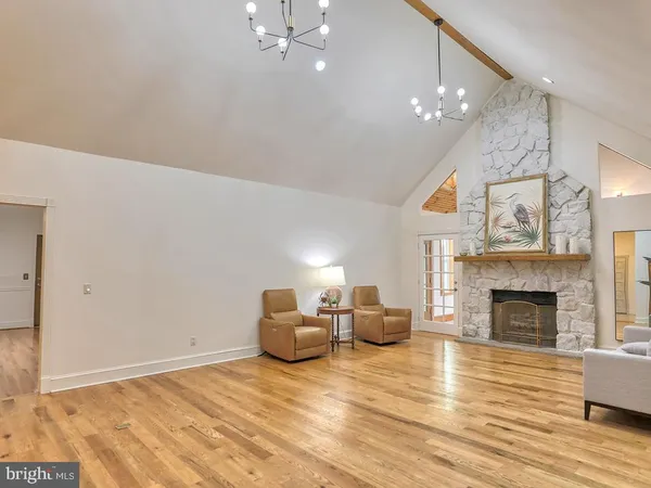 a spacious bathroom with a tub sink and mirror