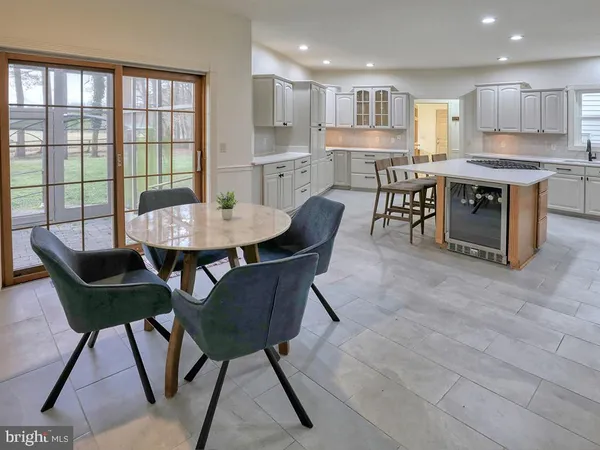 a spacious bathroom with a granite countertop double vanity and a mirror