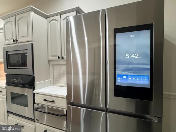 a front view of a house with a yard table and large trees