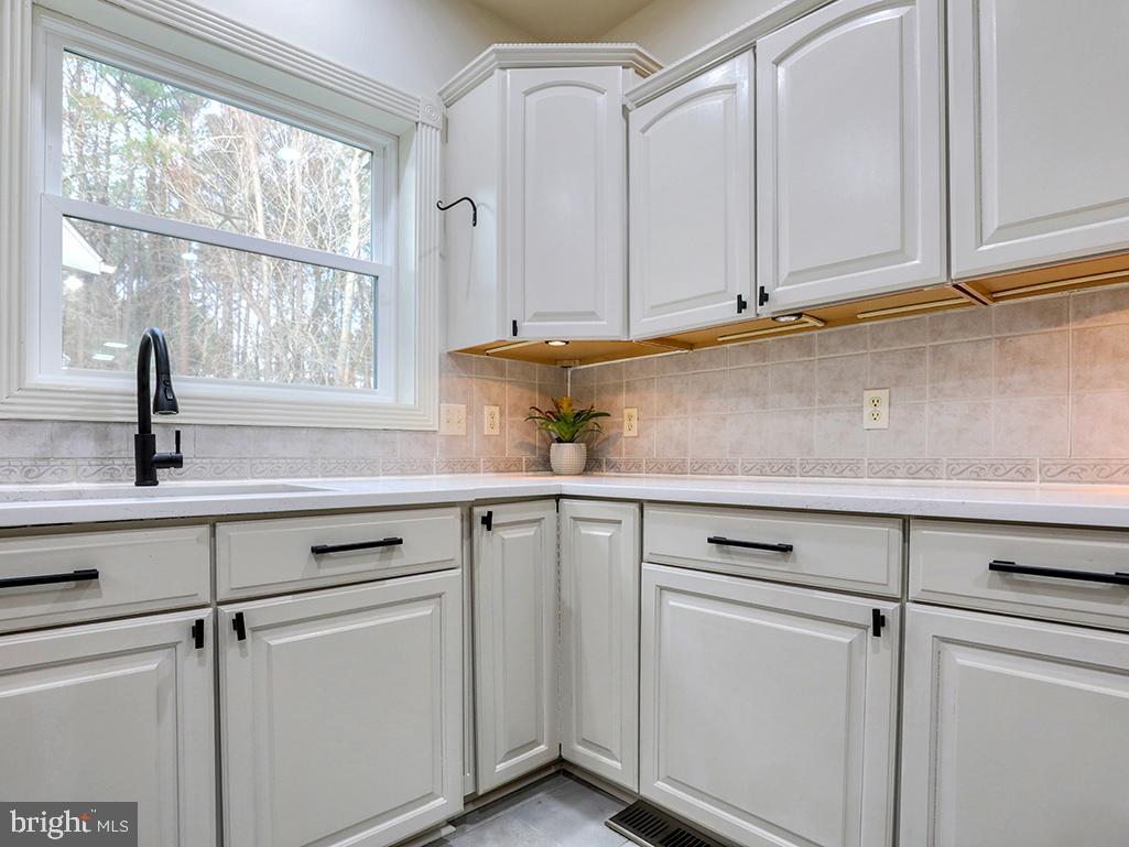 6 Cinderberry Court Georgetown, DE 19947 - Photo 22 of 117 a kitchen with white cabinets and sink