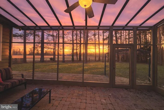 a view of a house with a yard patio and fire pit