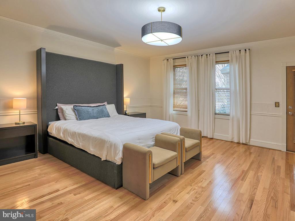 6 Cinderberry Court Georgetown, DE 19947 - Photo 34 of 117 a spacious bedroom with a bed and a chandelier