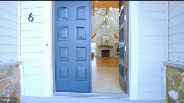 a kitchen with white cabinets and sink
