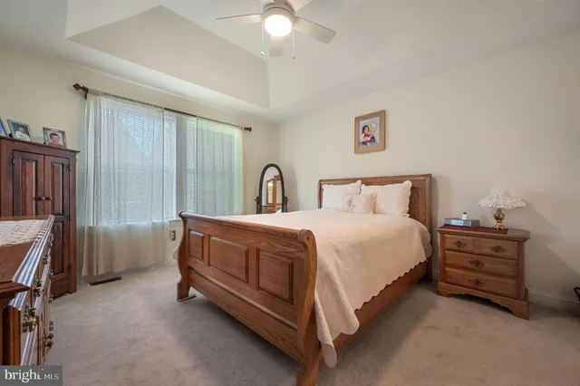 a spacious bedroom with a bed and a chandelier
