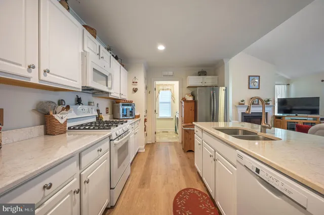 a kitchen with stainless steel appliances granite countertop a sink and cabinets