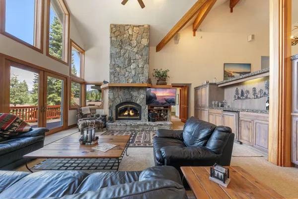 a living room with furniture a fireplace and a table