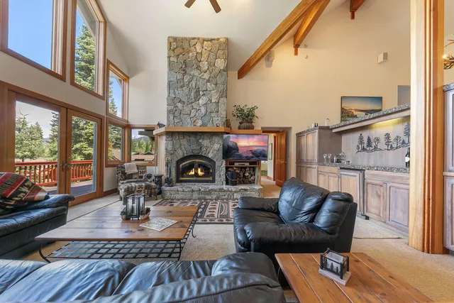 a living room with furniture a fireplace and a table