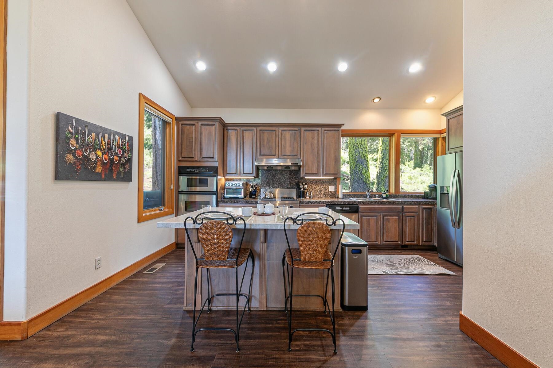 1141 Snow Crest Road Alpine Meadows, CA 96146 - Photo 11 of 27 a kitchen with a table chairs refrigerator and cabinets