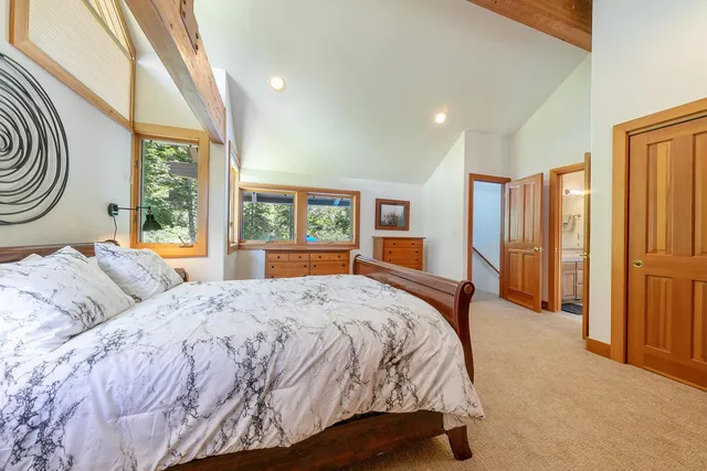 a bedroom with a large bed and a window