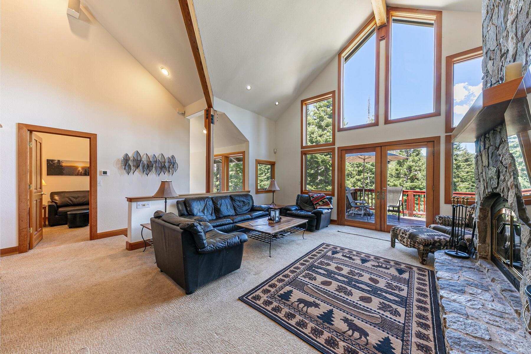 1141 Snow Crest Road Alpine Meadows, CA 96146 - Photo 4 of 27 a living room with furniture large window and a fireplace