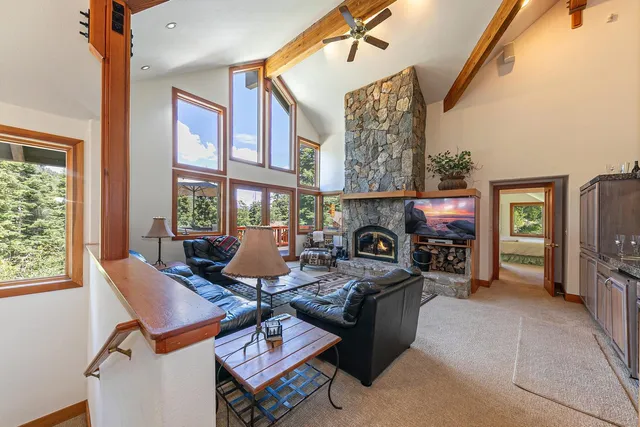 a living room with furniture a fireplace and a window