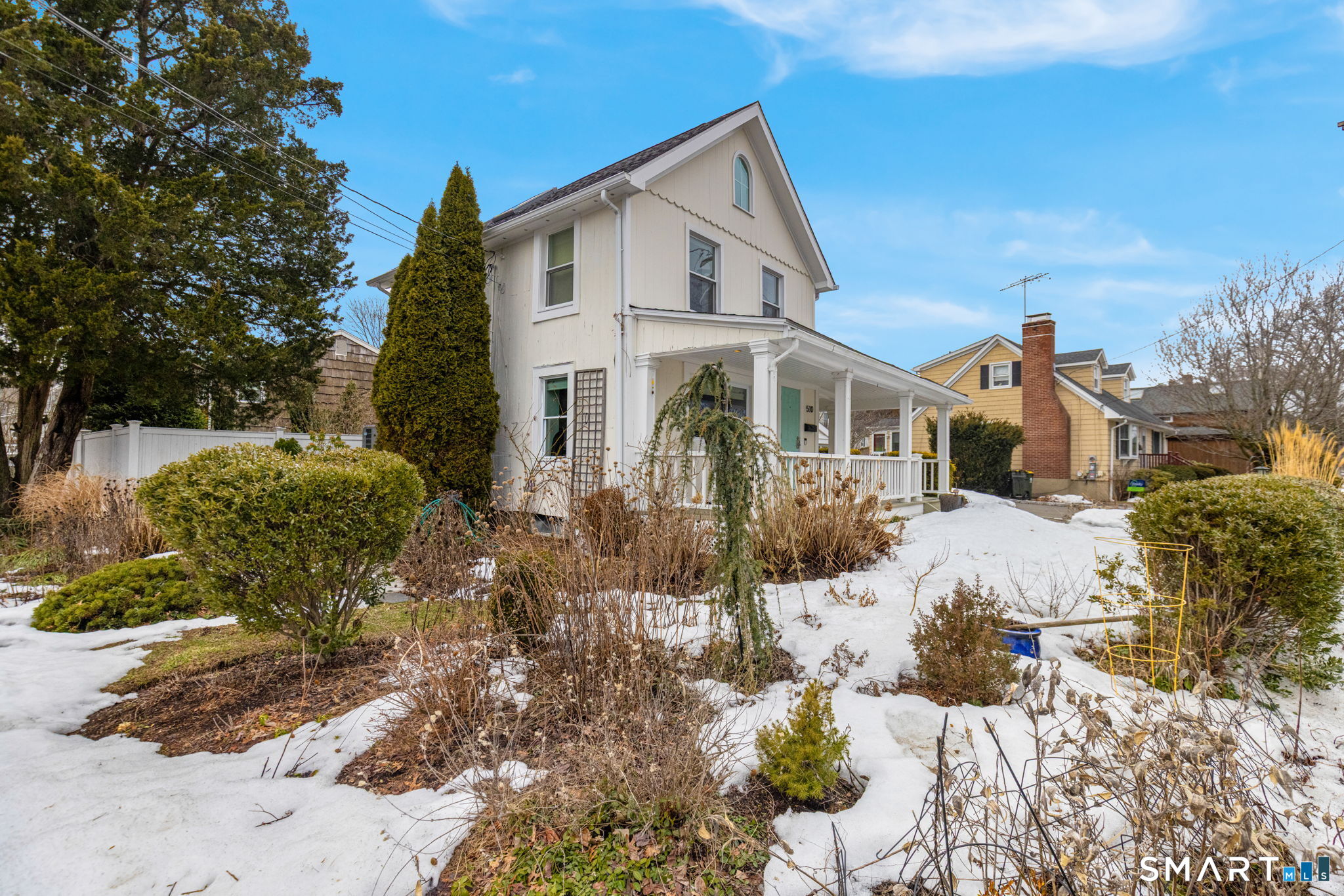 510 Reef Road Fairfield, CT 06824 - Photo 25 of 31 a front view of a house with a yard covered with snow