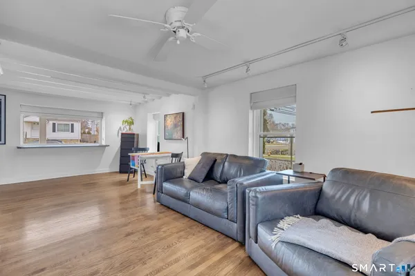 a living room with furniture and a wooden floor