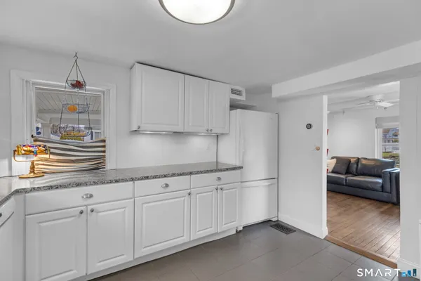 a kitchen with stainless steel appliances granite countertop a sink a stove and a refrigerator
