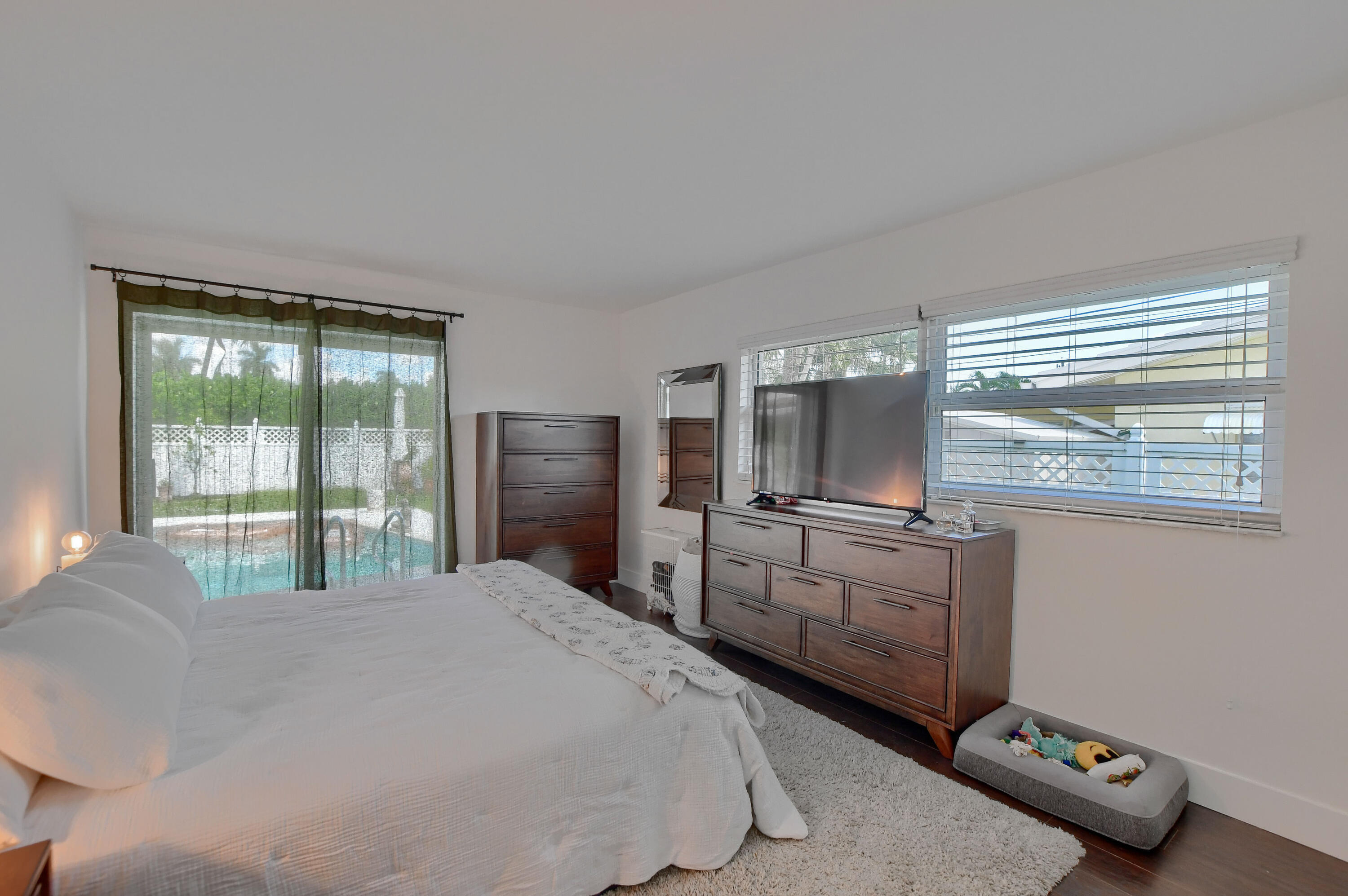 1167 Southwest 13th Drive Boca Raton, FL 33486 - Photo 19 of 41 a bedroom with a bed and a flat tv screen on dresser