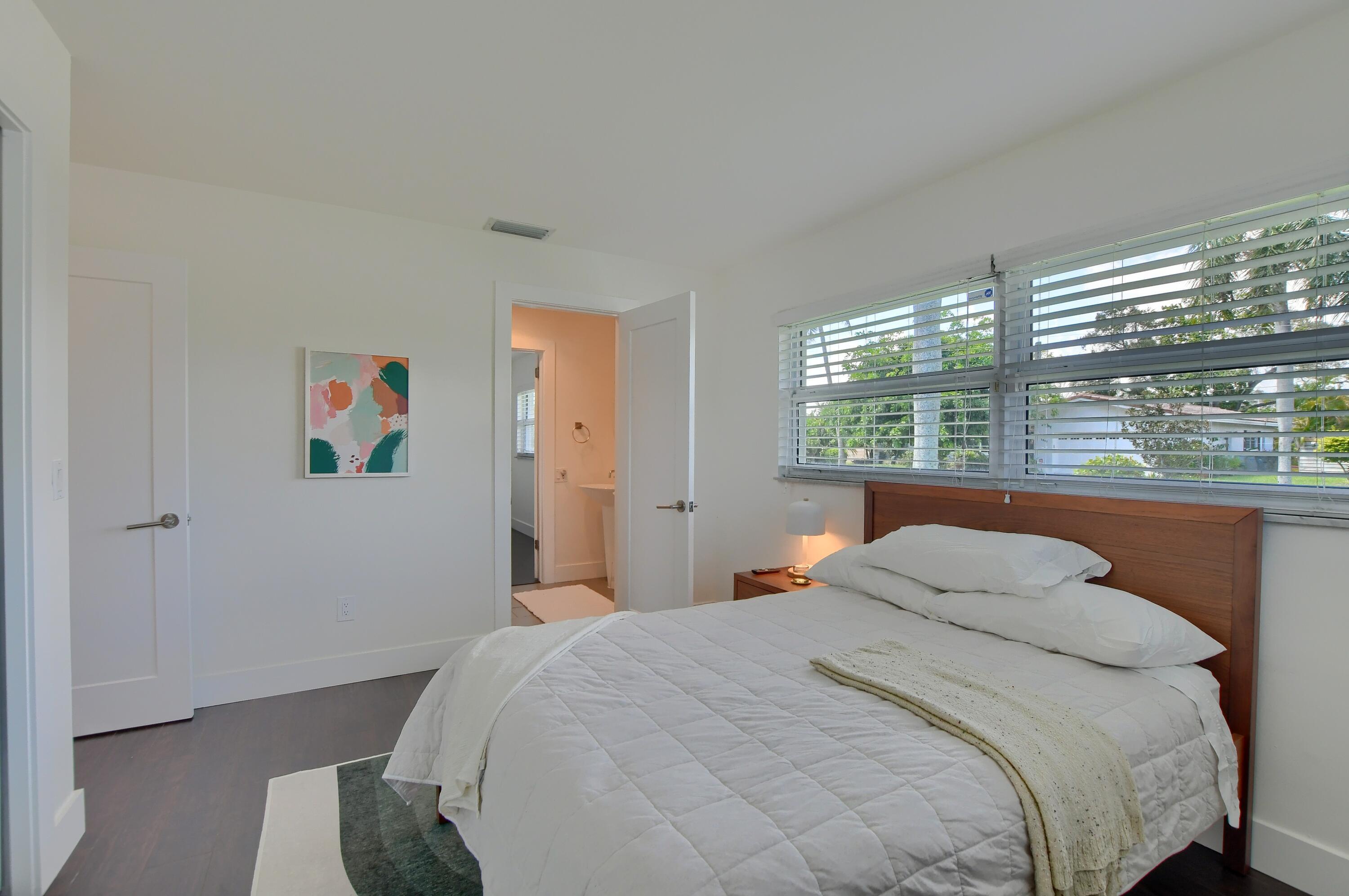 1167 Southwest 13th Drive Boca Raton, FL 33486 - Photo 23 of 41 a bedroom with a bed and a painting on the wall