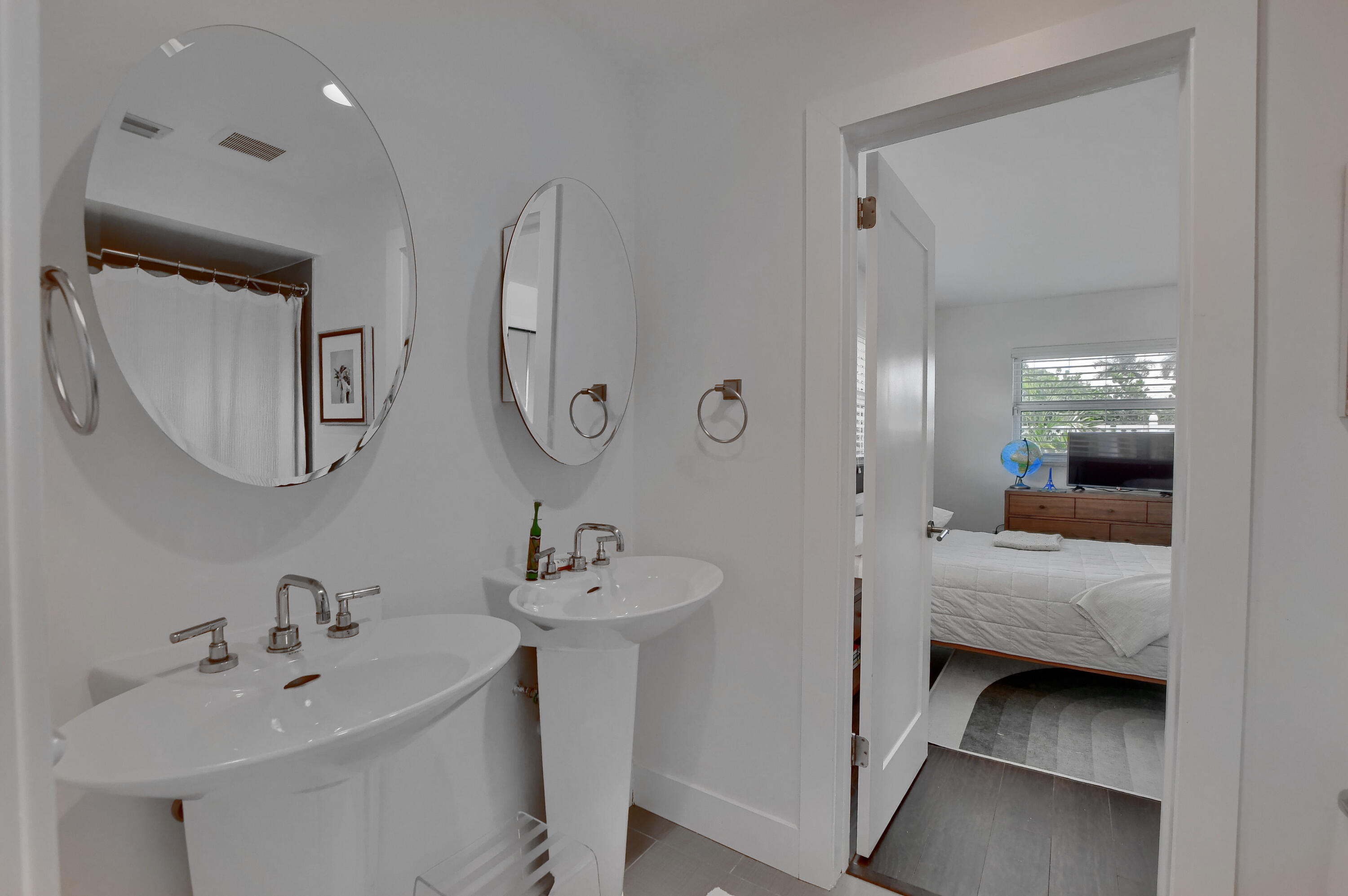 1167 Southwest 13th Drive Boca Raton, FL 33486 - Photo 25 of 41 a en suite bathroom with a double vanity sink and mirror