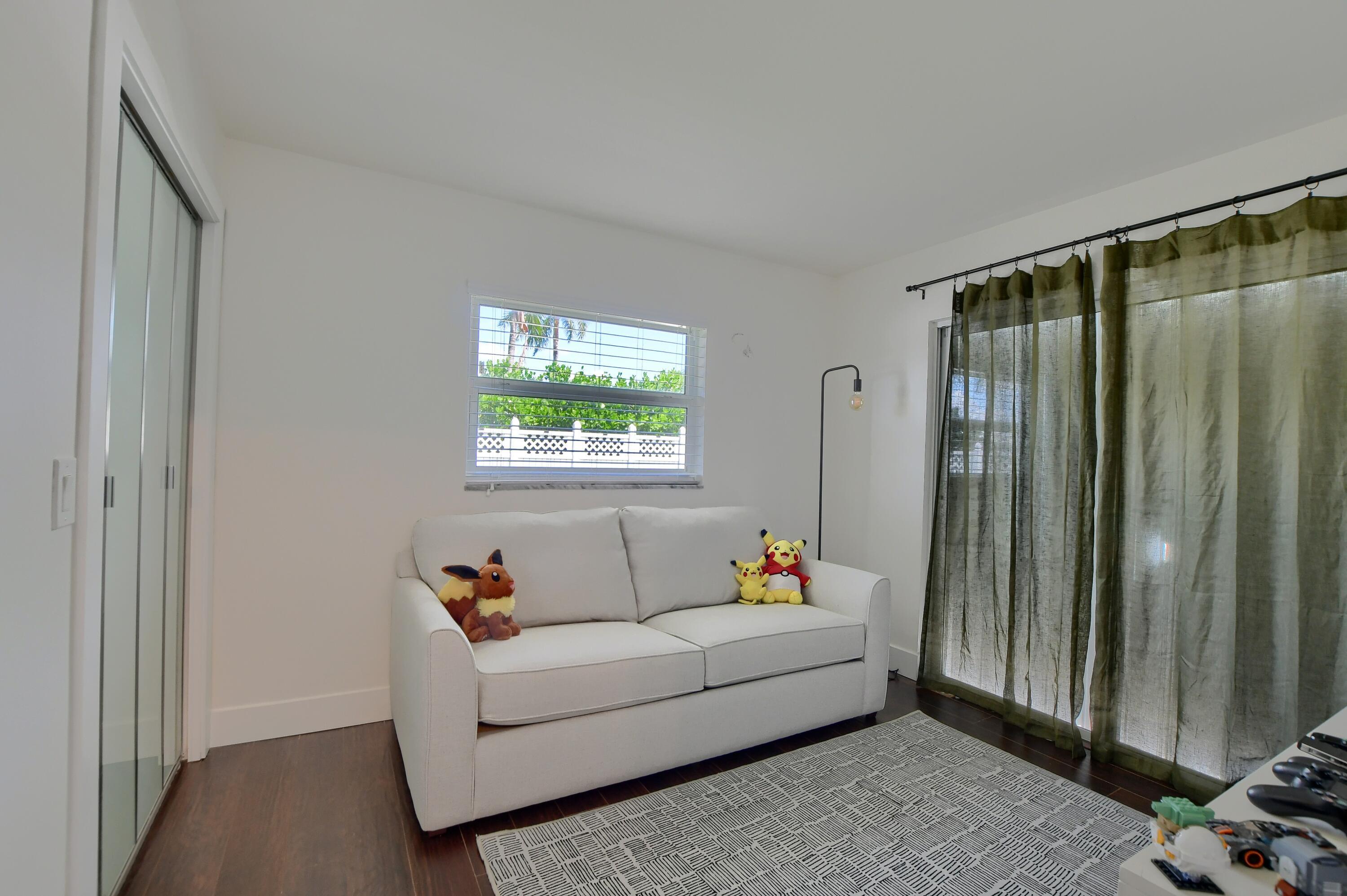 1167 Southwest 13th Drive Boca Raton, FL 33486 - Photo 30 of 41 a living room with furniture and a window