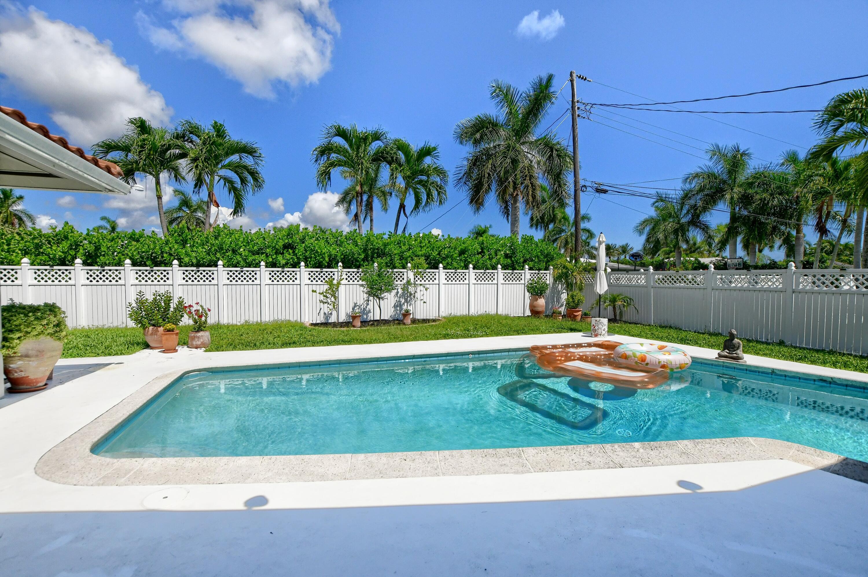 1167 Southwest 13th Drive Boca Raton, FL 33486 - Photo 35 of 41 a view of a swimming pool with a sitting space