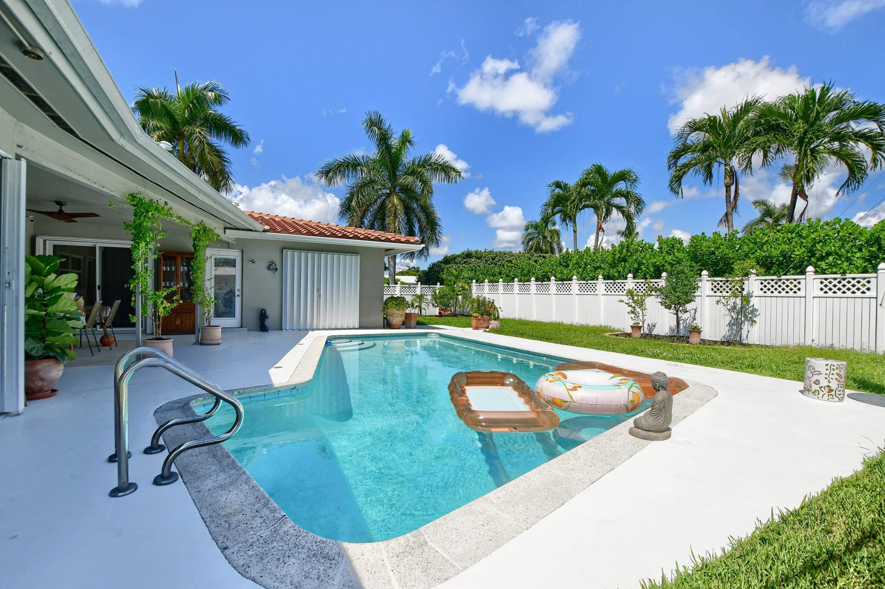 1167 Southwest 13th Drive Boca Raton, FL 33486 - Photo 37 of 41 a view of a house with swimming pool and sitting area