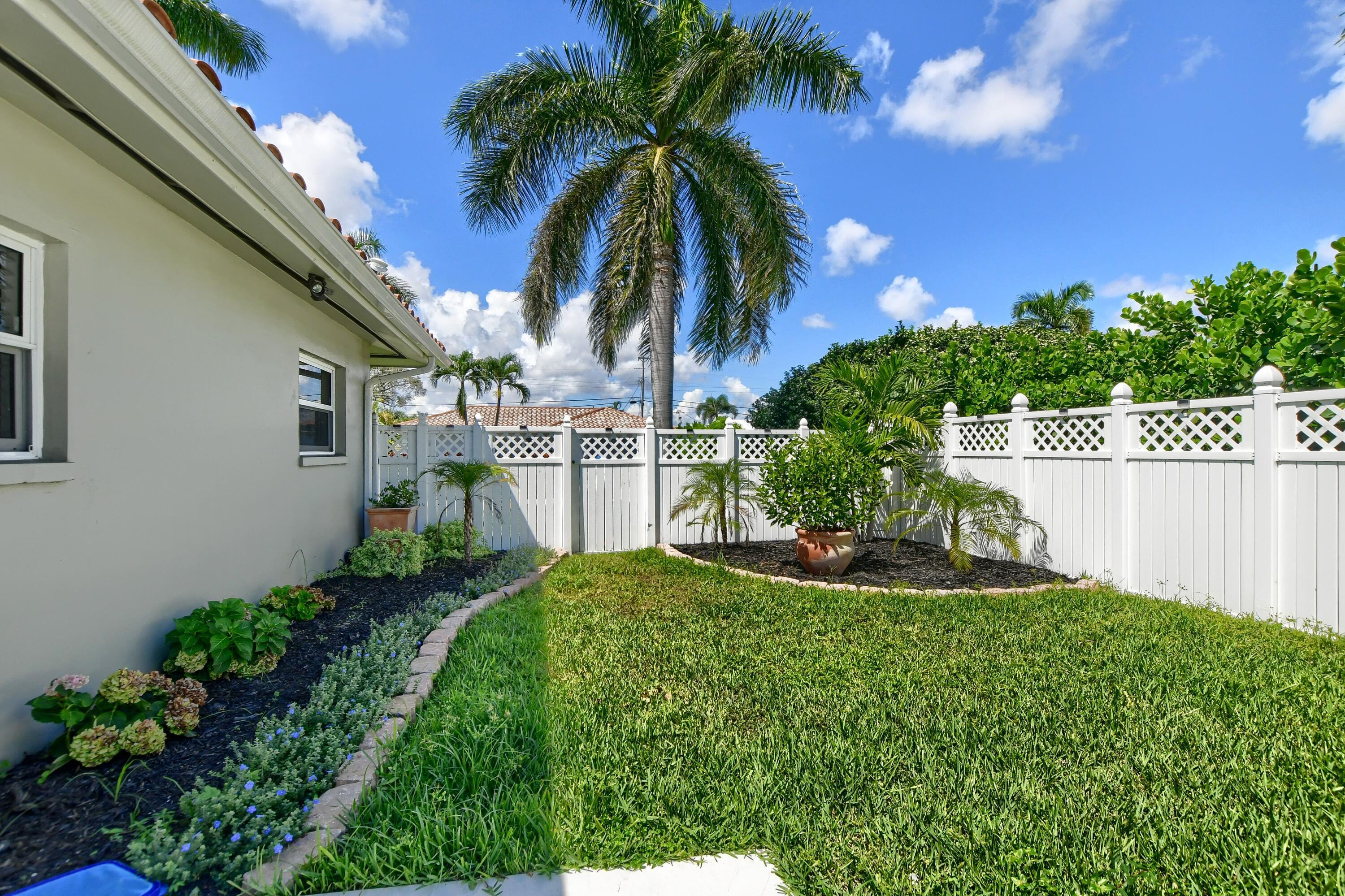 1167 Southwest 13th Drive Boca Raton, FL 33486 - Photo 38 of 41 a view of an house with backyard space and garden