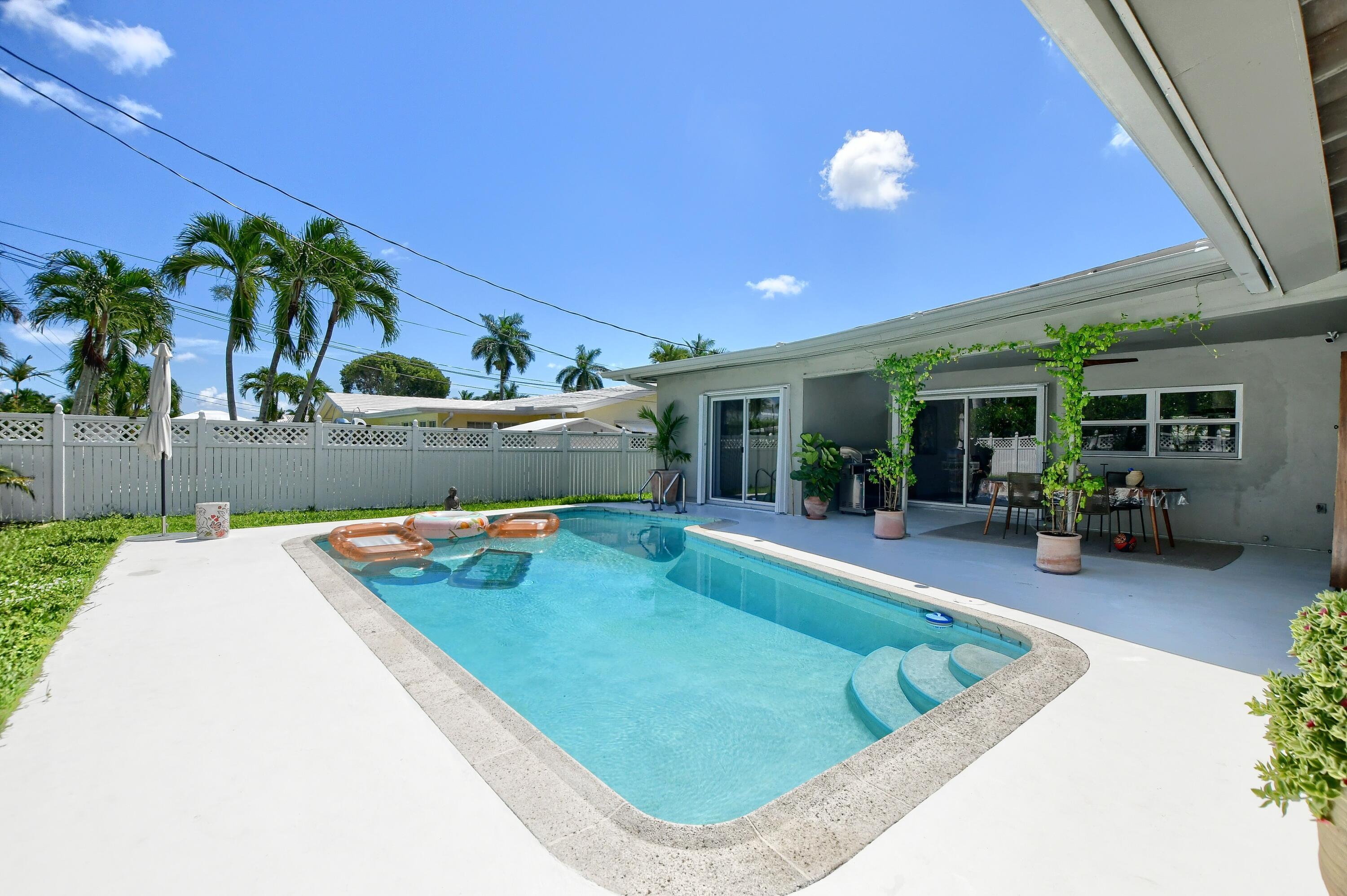 1167 Southwest 13th Drive Boca Raton, FL 33486 - Photo 39 of 41 a view of a backyard with plants and a patio