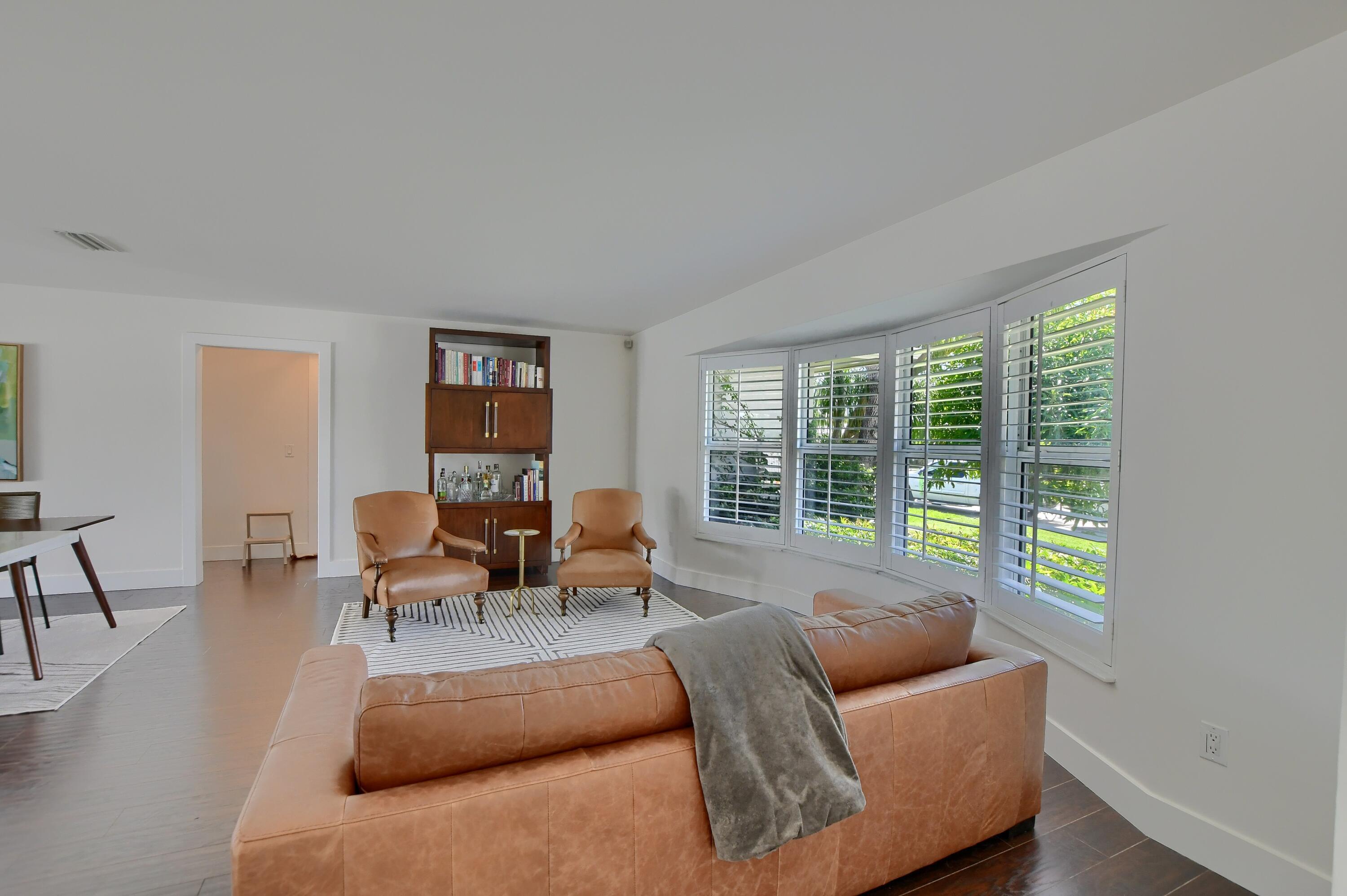 1167 Southwest 13th Drive Boca Raton, FL 33486 - Photo 4 of 41 a living room with furniture and a large window