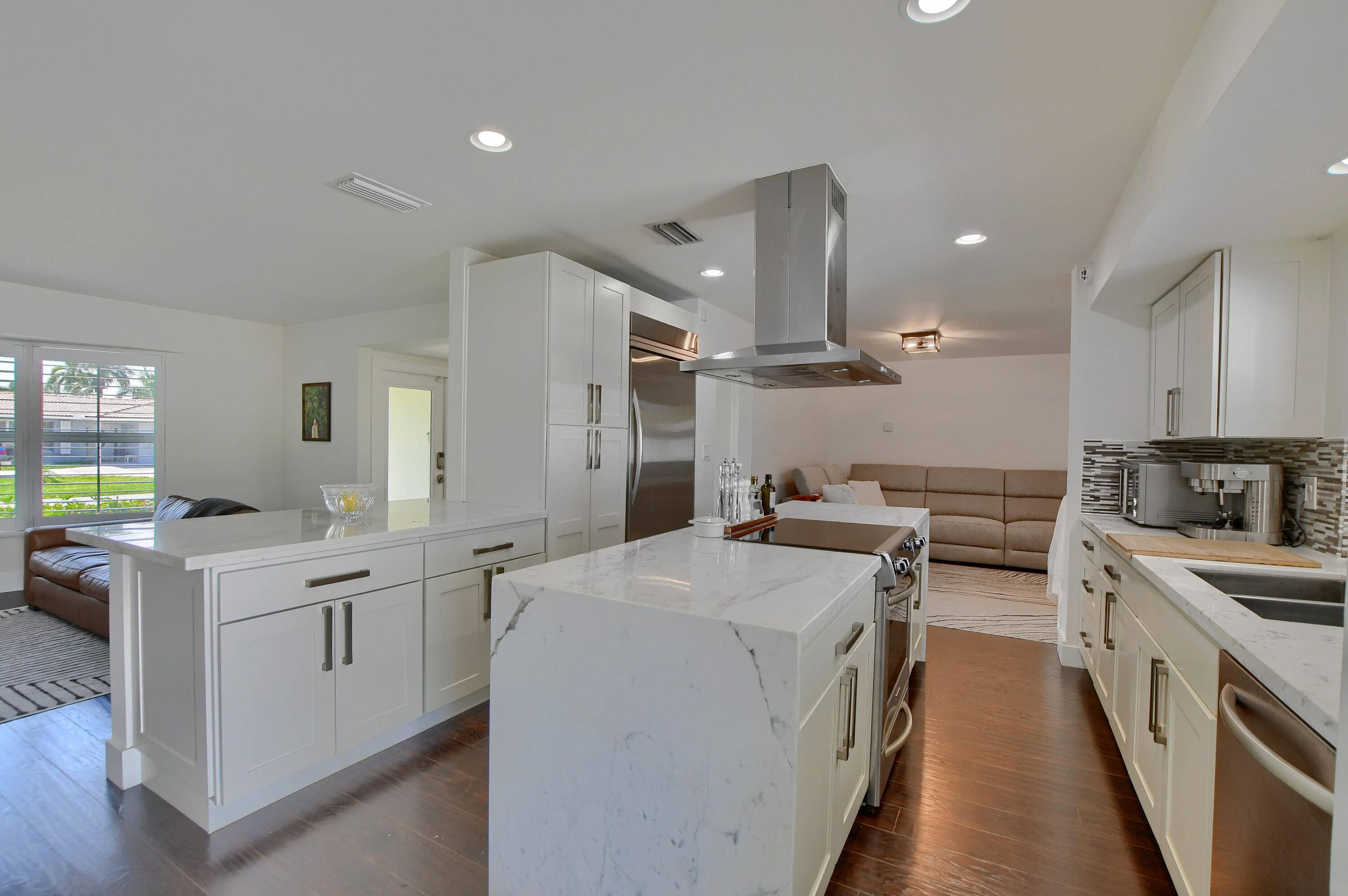 1167 Southwest 13th Drive Boca Raton, FL 33486 - Photo 7 of 41 a kitchen with a sink stove and wooden cabinets