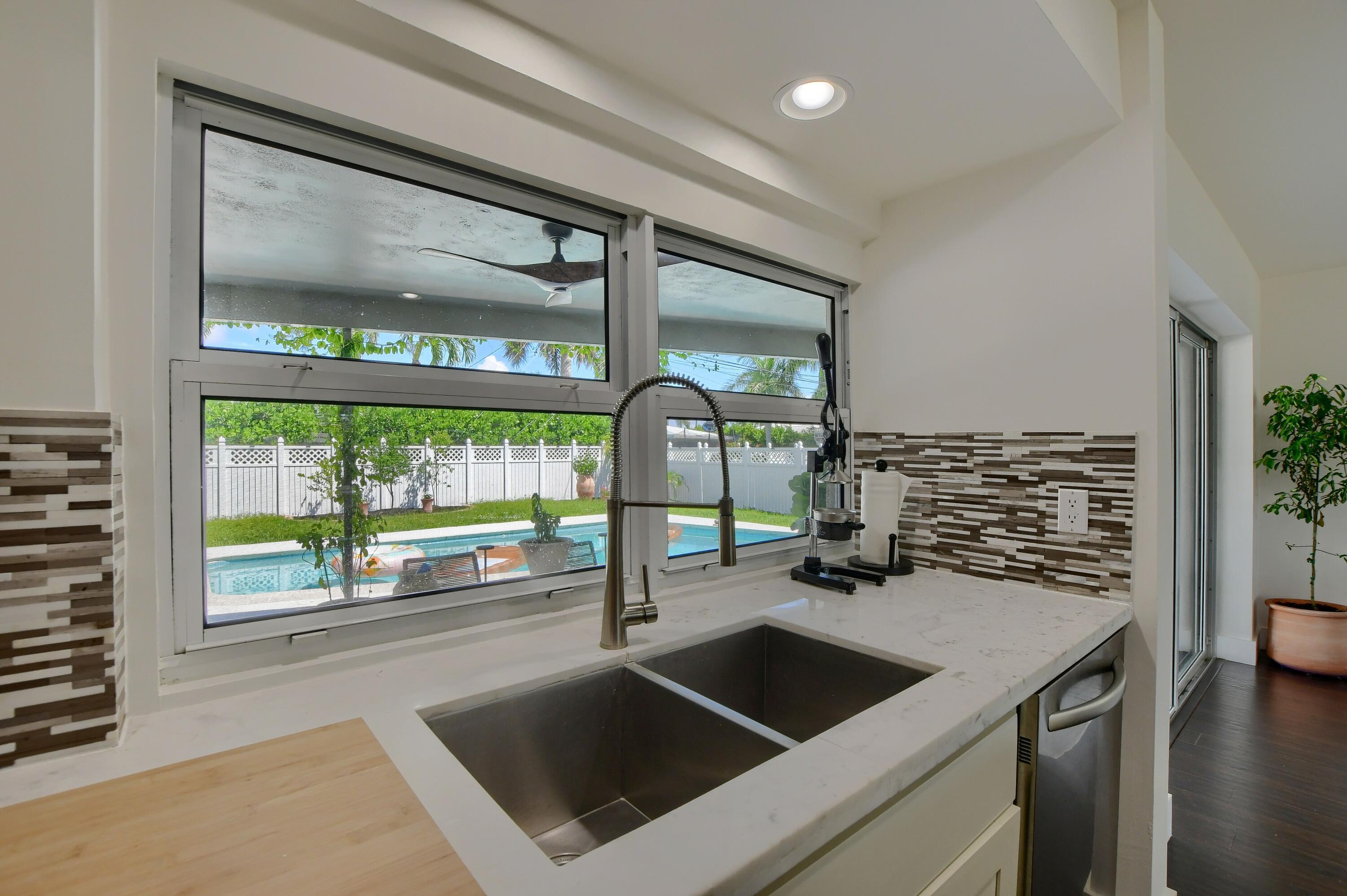 1167 Southwest 13th Drive Boca Raton, FL 33486 - Photo 10 of 41 a kitchen with a sink and a large window