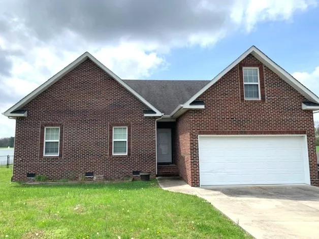 a front view of a house with a yard and garage