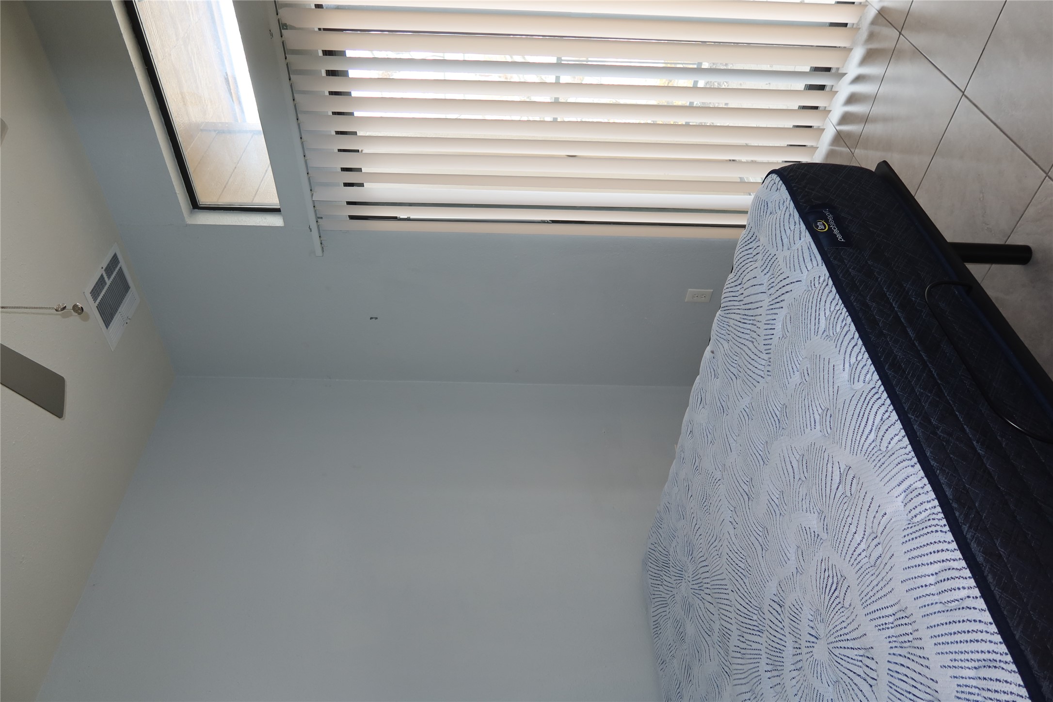 2802 Nueces Street, Unit 306 Austin, TX 78705 - Photo 12 of 20 Bedroom featuring light blue walls, ceramic tile flooring, a ceiling fan, and a transom window above vertical blinds