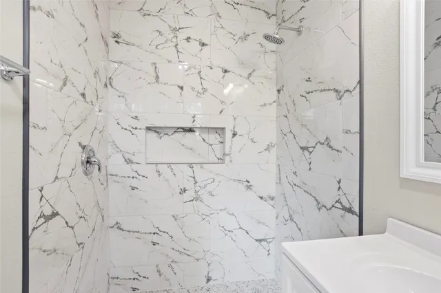 a bathroom with a bathtub and shower