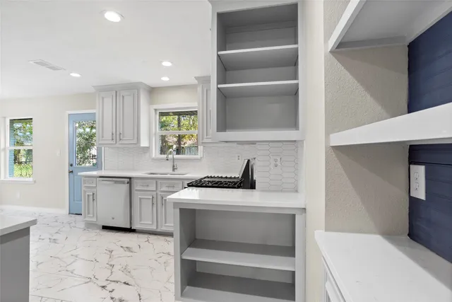 a kitchen with a sink stove and cabinets