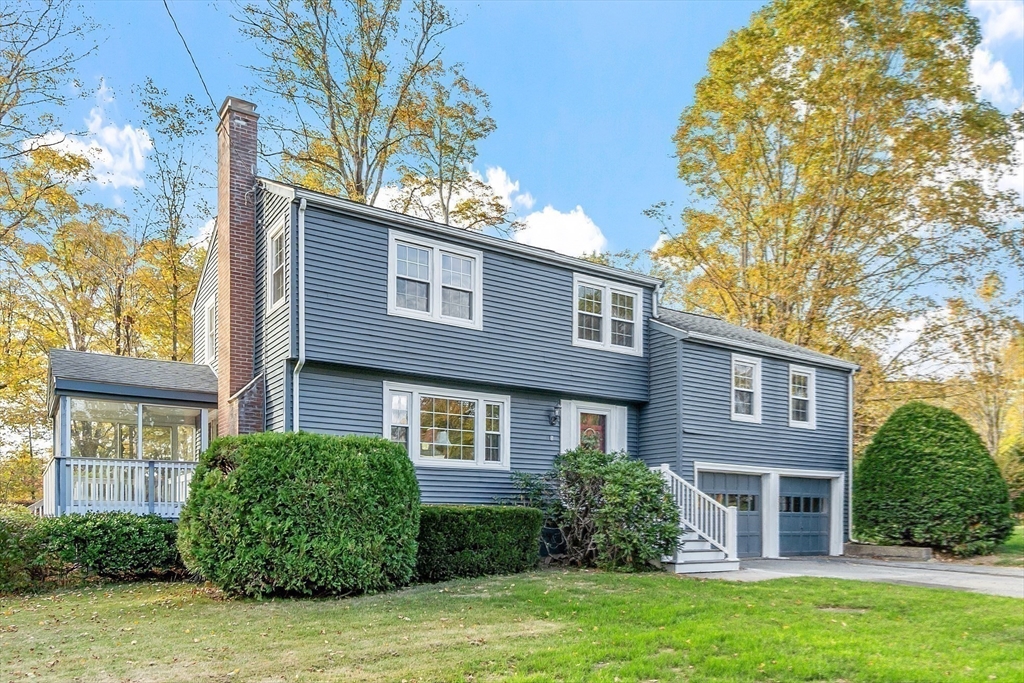 front view of a brick house with a yard