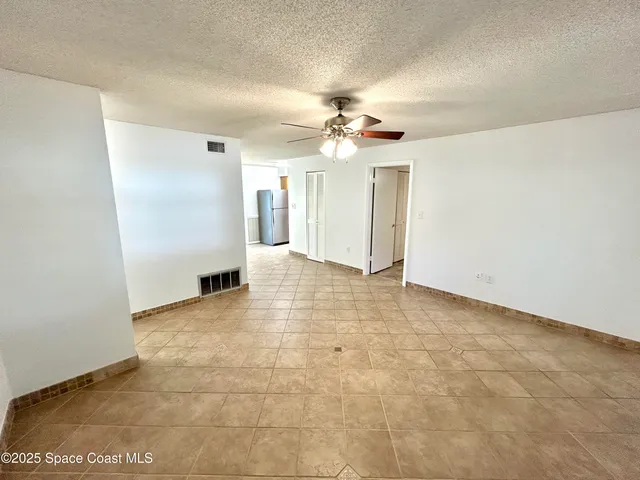 a view of an empty room with a chandelier