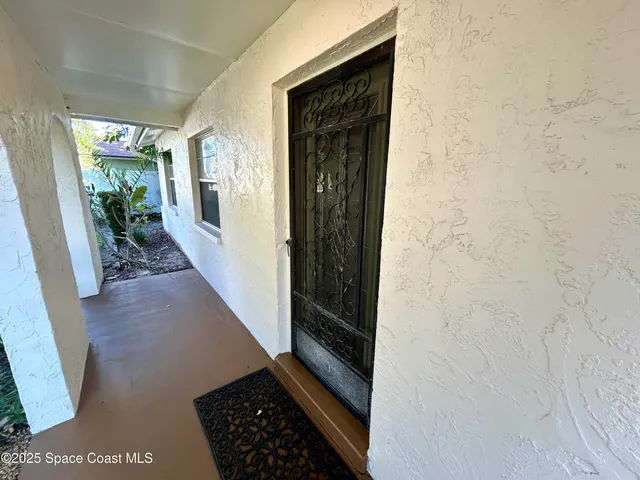 an empty room with closet and a chandelier fan