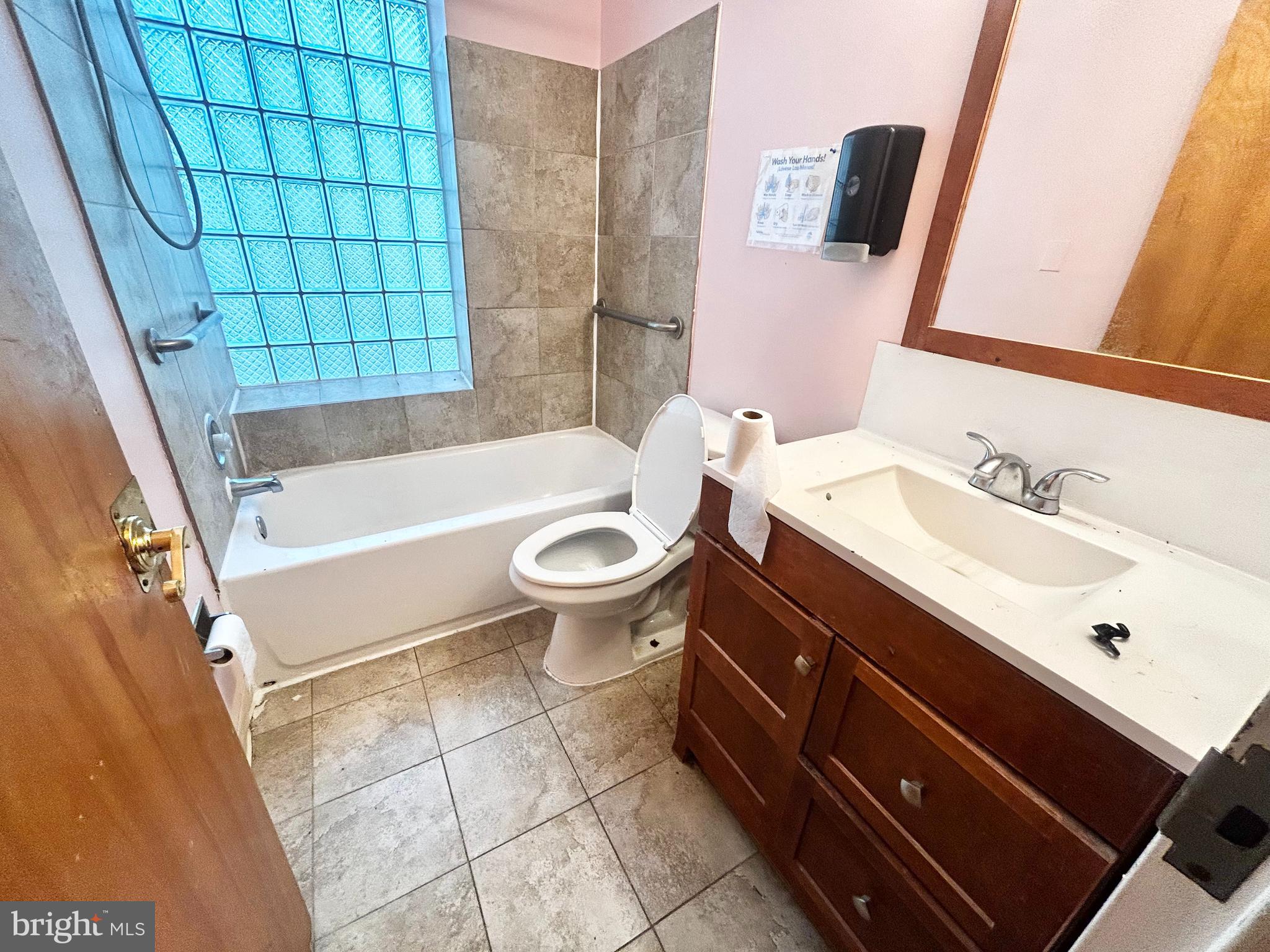 3824 Lancaster Avenue Philadelphia, PA 19104 - Photo 17 of 20 a bathroom with a sink a toilet and shower