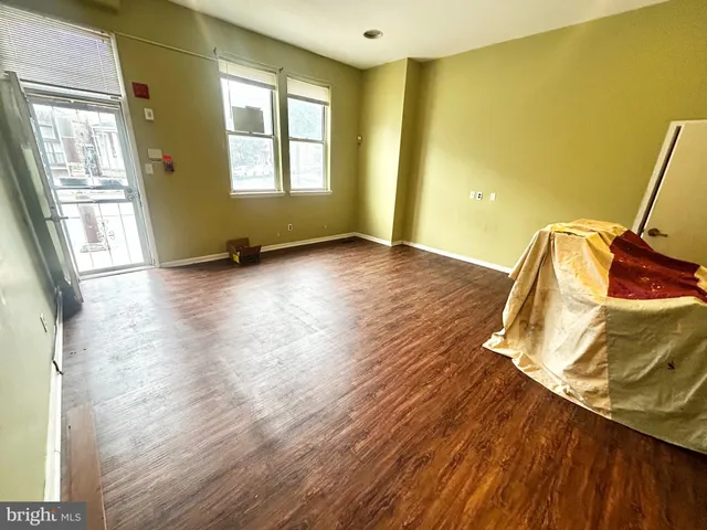 a view of a room with wooden floor and chair
