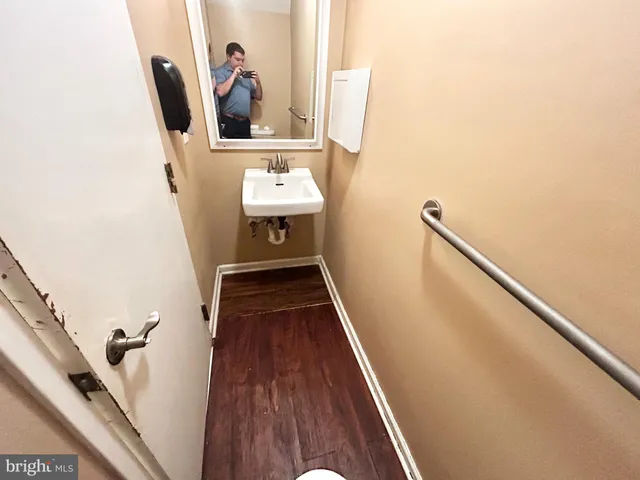 a view of water heater room with wooden floor