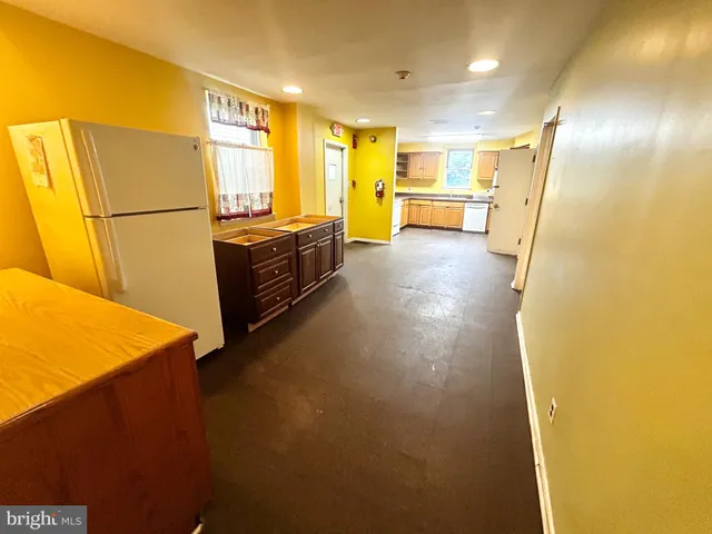 a view of a kitchen with a sink and a refrigerator